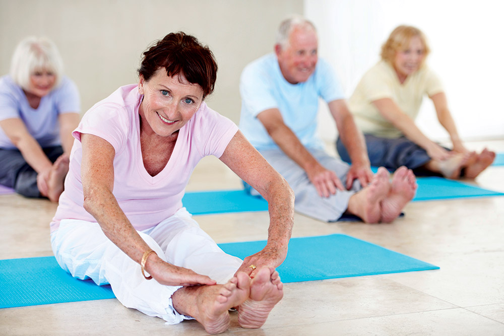 Seniors doing yoga stretching