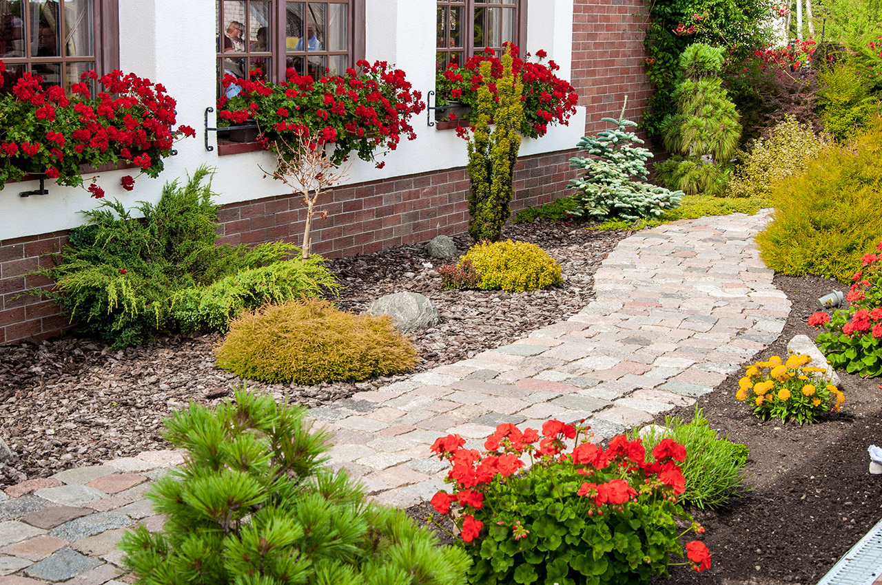 Nursing home outdoor walkway with landscaping and flowers