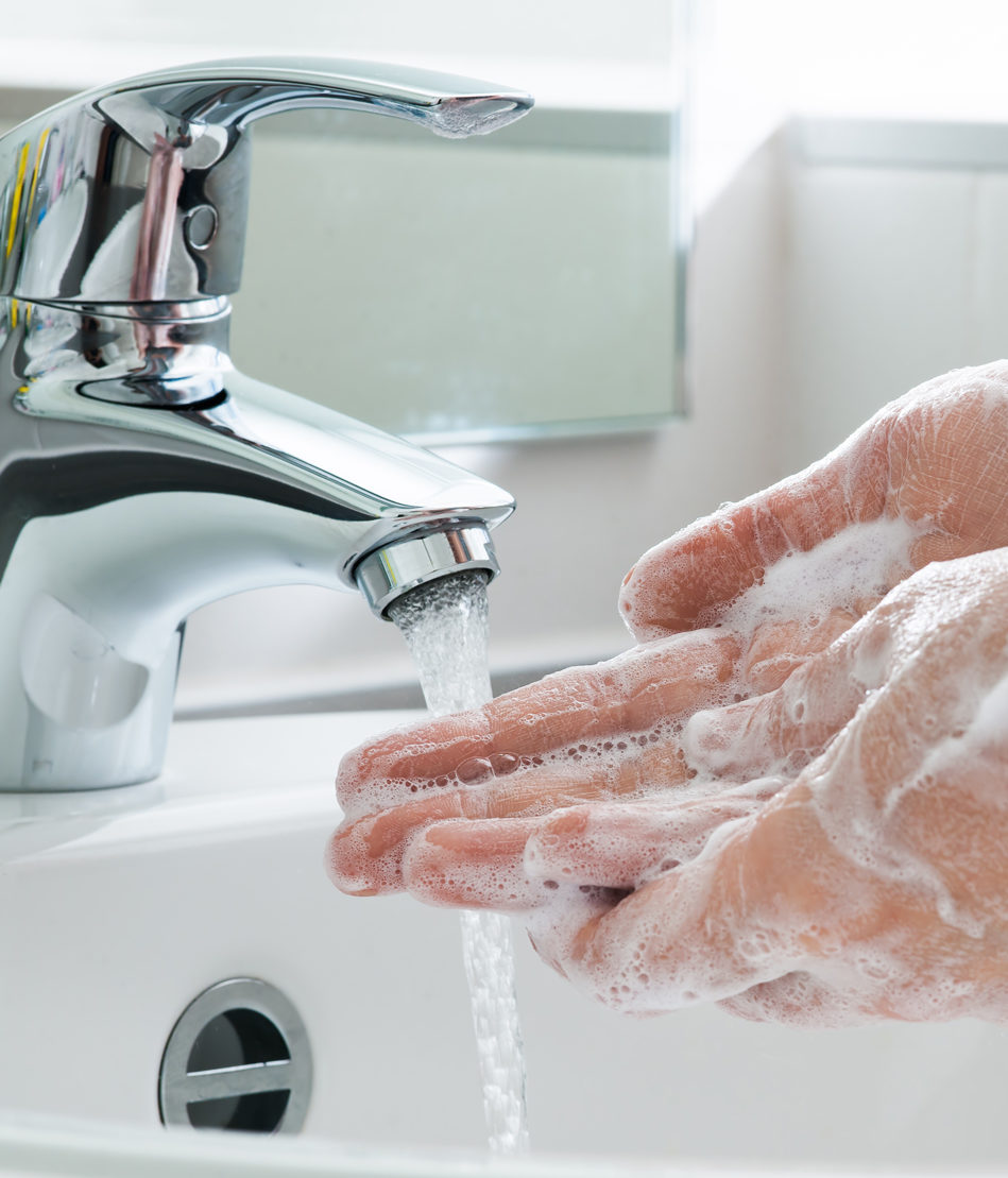 Washing hands with soap under running water