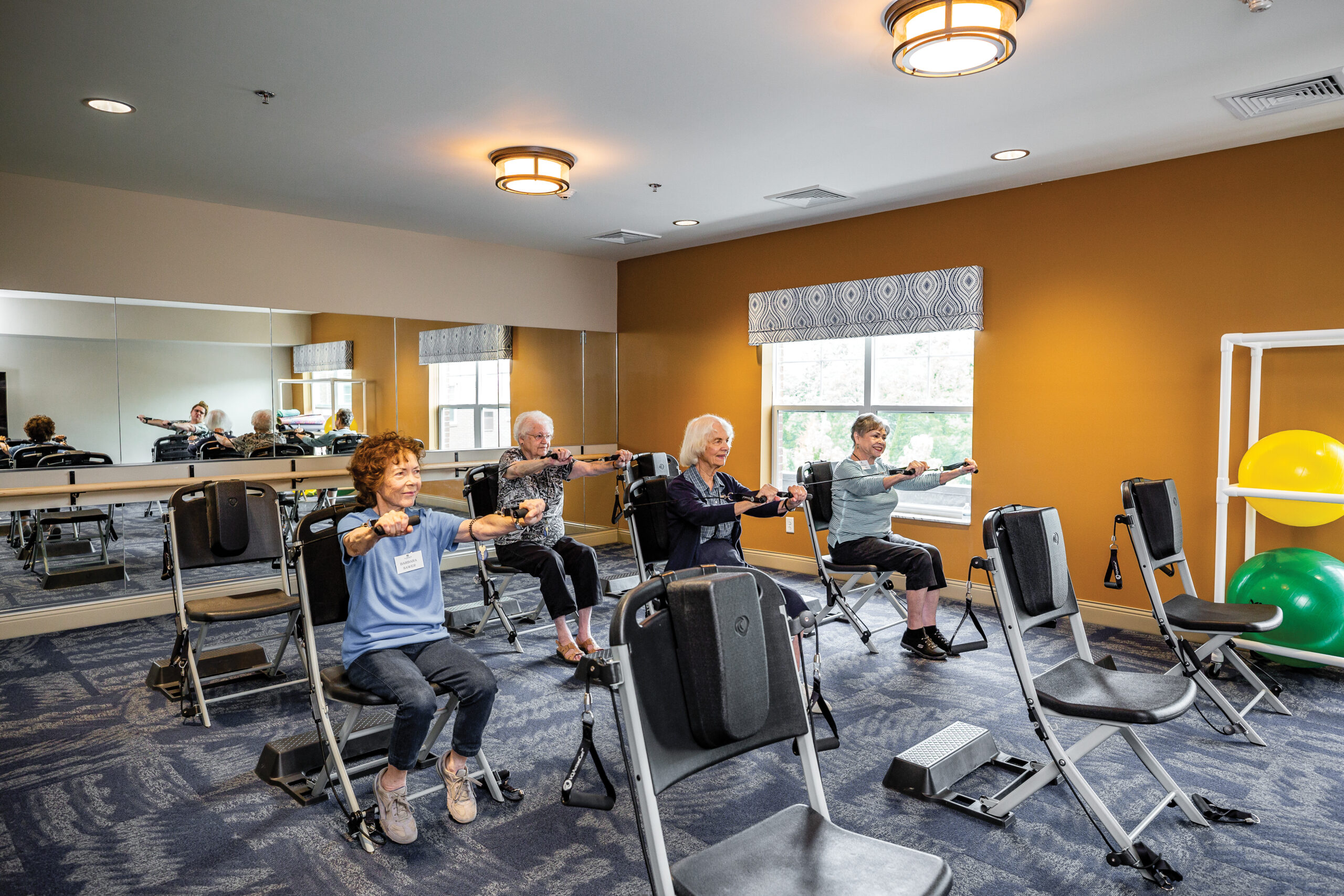 Four women exercising in workout room