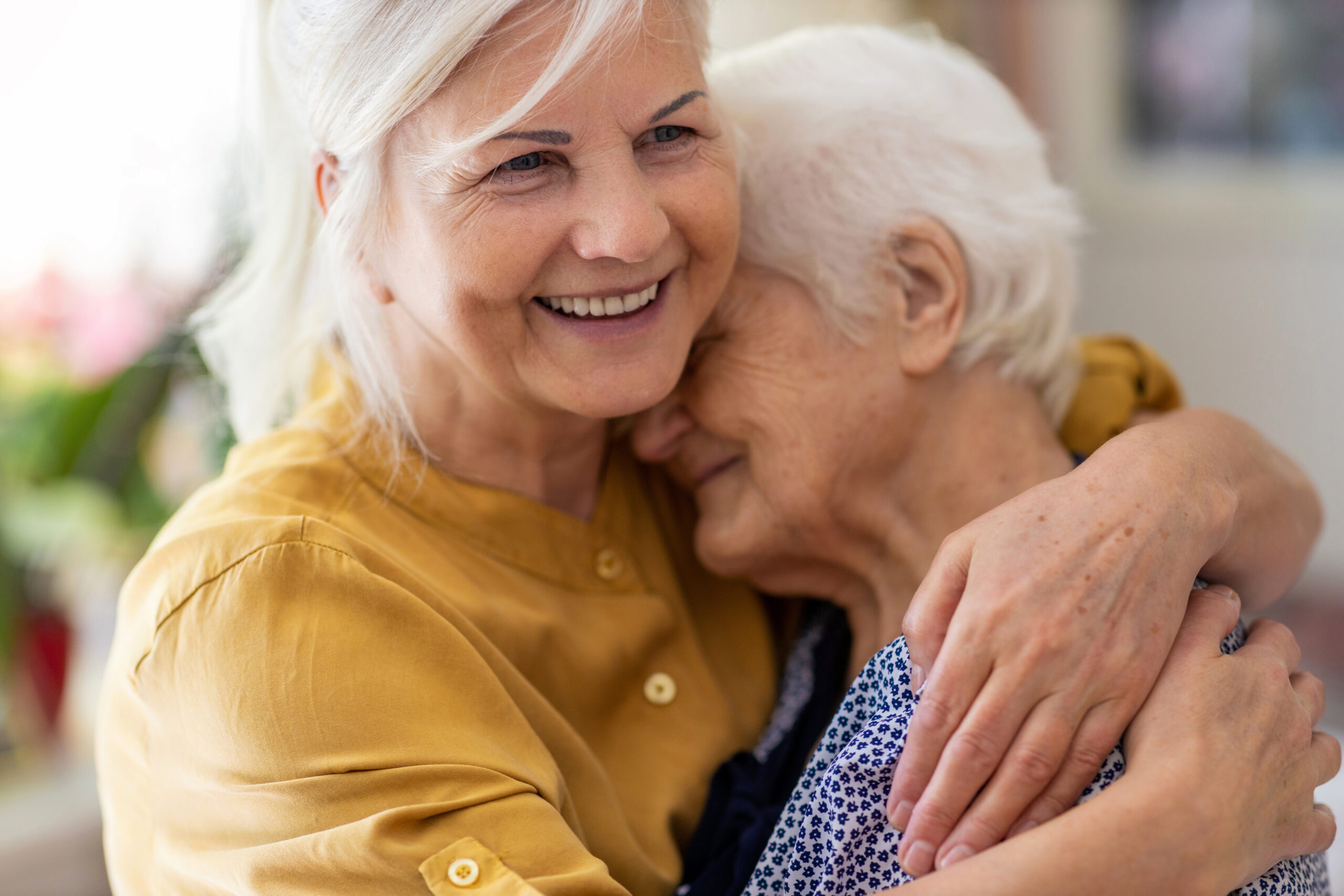 Woman spending time with her elderly mother Technology for senior living real-time location systems using wi-fi benefits residents
