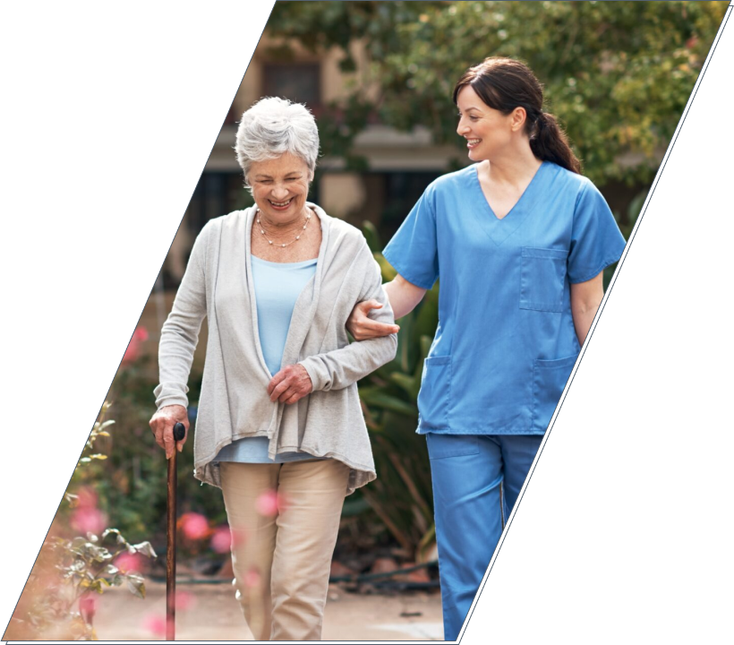 Senior woman walking outside with caregiver