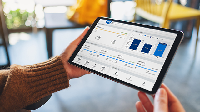 hands holding tablet showing bar graph