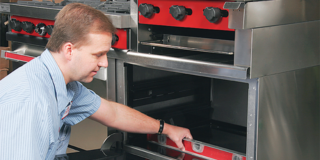 person installing a commercial grade oven