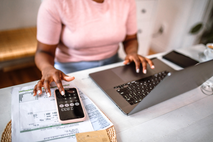 budgeting with cmms woman using smartphone and computer